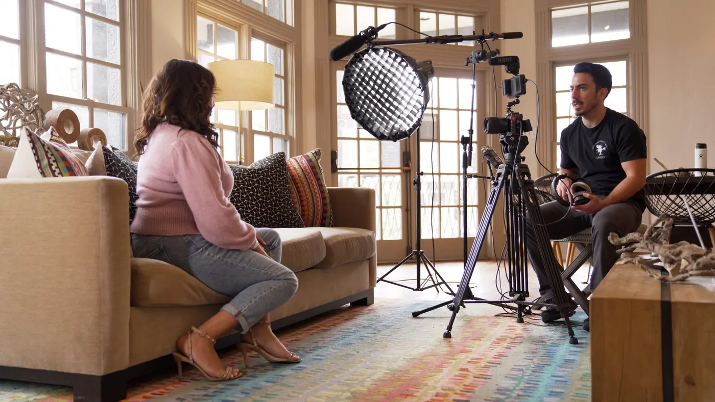 Evan Lopez, founder of Stellar Roots Media, interviewing a client on location